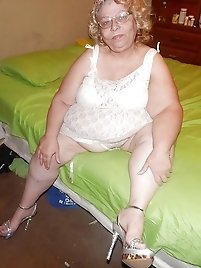 Hairy chubby bitch is posing seminaked at home